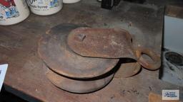 antique wooden pulley with metal frame