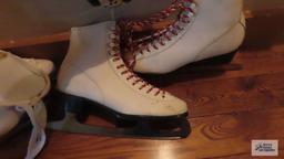 Pair of child and pair of adult white ice skates