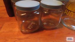 Assorted glass containers with screw on lids