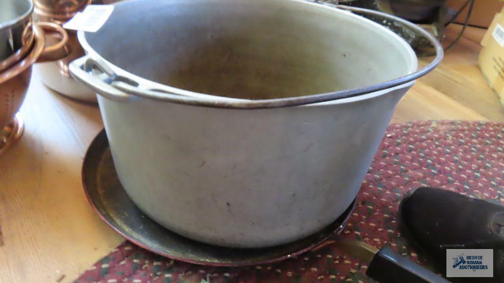 Large stainless steel pot. Heavy duty cast iron kettle. Other kitchen items
