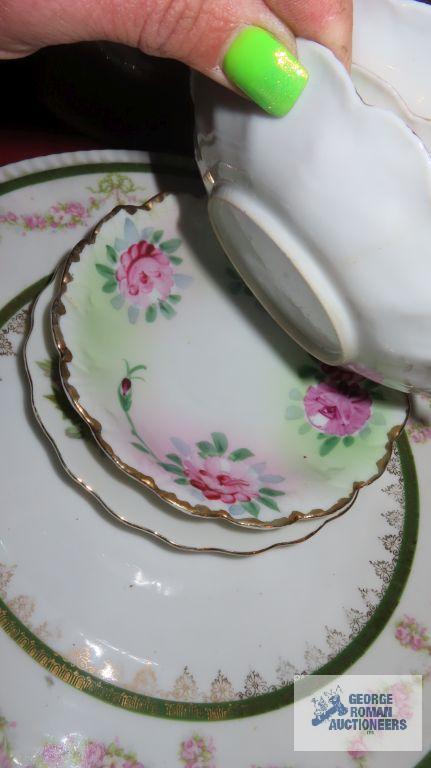 Variety of vintage dishes, plates, and saucers