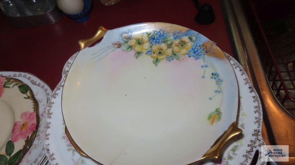 Variety of vintage dishes, plates, and saucers