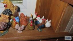 Windowsill full of chicken and rooster figurines