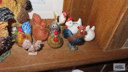Windowsill full of chicken and rooster figurines