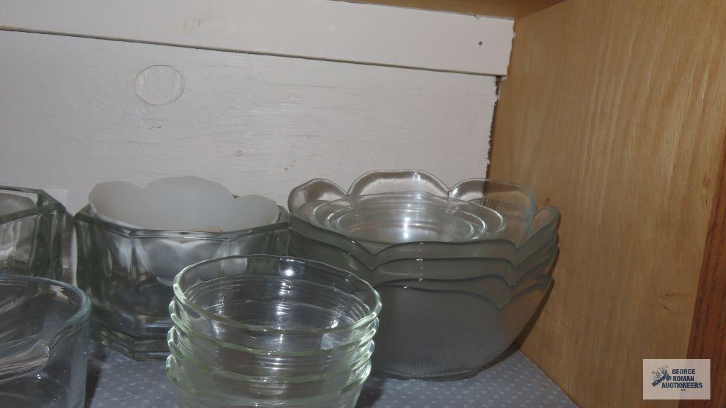 Cupboard lot of glass dishes,...Christmas glassware and mugs