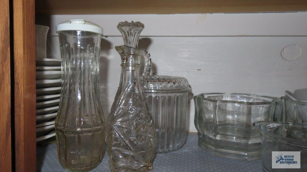 Cupboard lot of glass dishes,...Christmas glassware and mugs