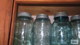 Shelf lot of vintage canning jars with zinc lids
