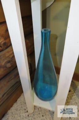 Wooden plant stand with blue glass vase