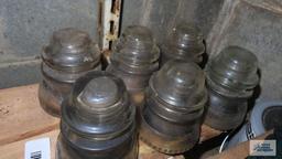 Six vintage clear glass insulators