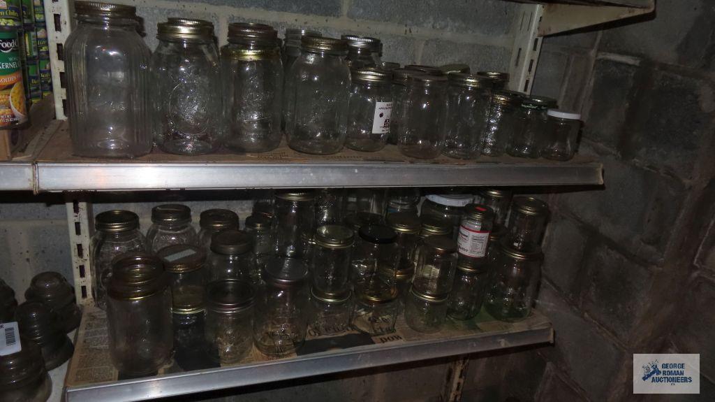 Two shelves of assorted jars