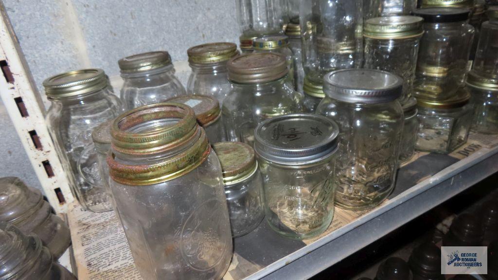 Two shelves of assorted jars