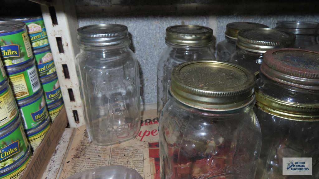 Two shelves of assorted jars