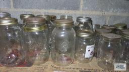 Two shelves of assorted jars