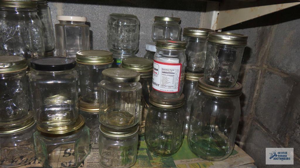 Two shelves of assorted jars