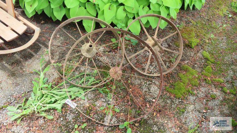 Three antique metal wheels