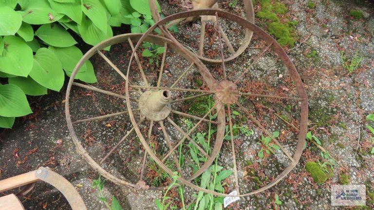 Three antique metal wheels