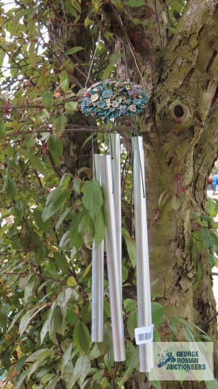 Metal wheelbarrow, wind chimes, girls sitting yard decoration, and seashells