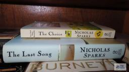 Shelf lot of leisure reading, including Nicholas Sparks. Mitch Albom. John Grisham.