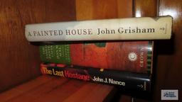 Shelf lot of leisure reading, including Nicholas Sparks. Mitch Albom. John Grisham.