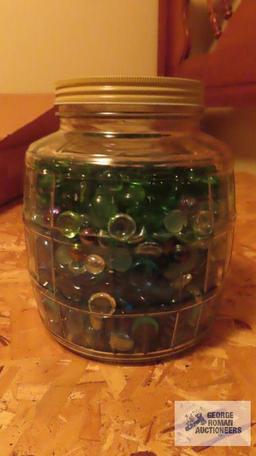 Vintage glass jar of colored stones and marbles