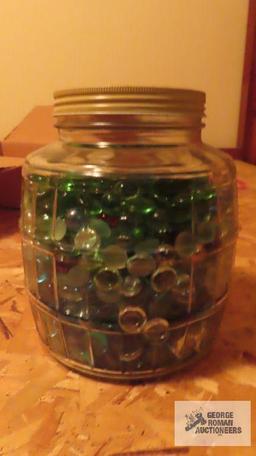 Vintage glass jar of colored stones and marbles