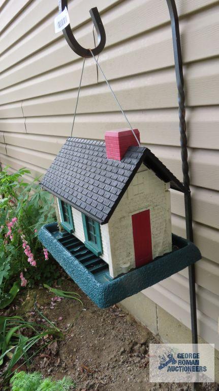 Plastic bird feeder with wrought iron shepherd's hook