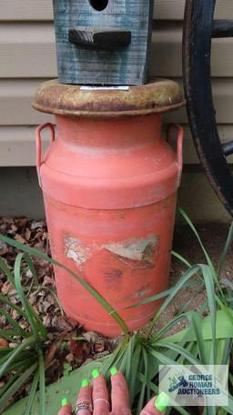 Orange milk can with birdhouse