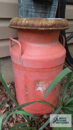 Orange milk can with birdhouse