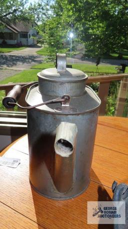 Tin container with handle, lid and spout