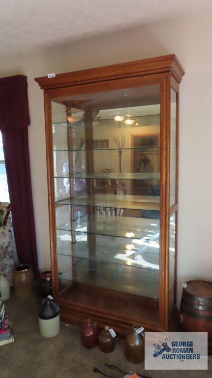Lighted curio with sliding front door