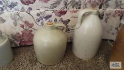 Two cream colored jugs with corks