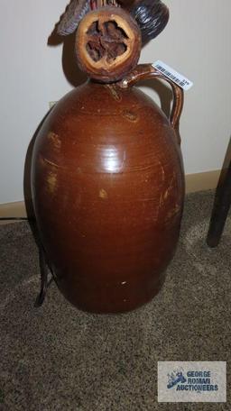 Large brown crock with artificial plants