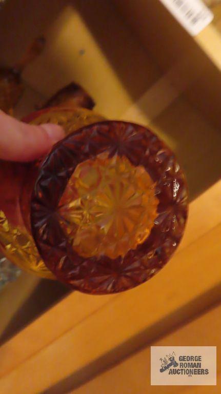 Amber colored glass bell, top hat, candle holder, and cup