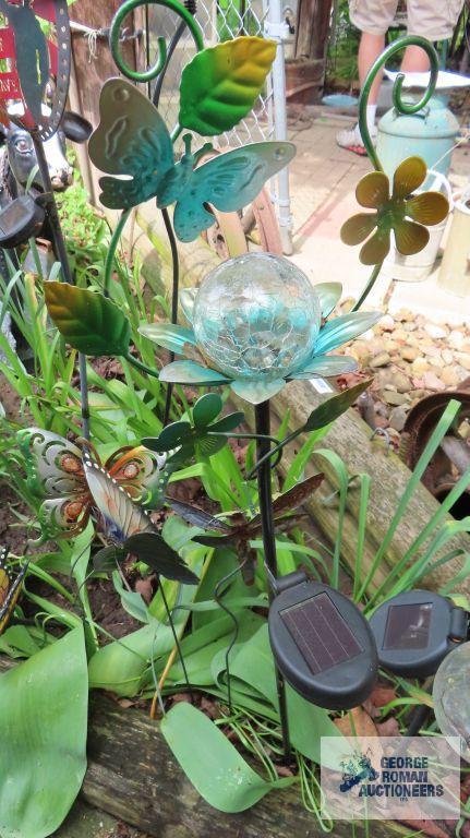 Lot of solar powered lighted yard decorations and butterfly yard decorations