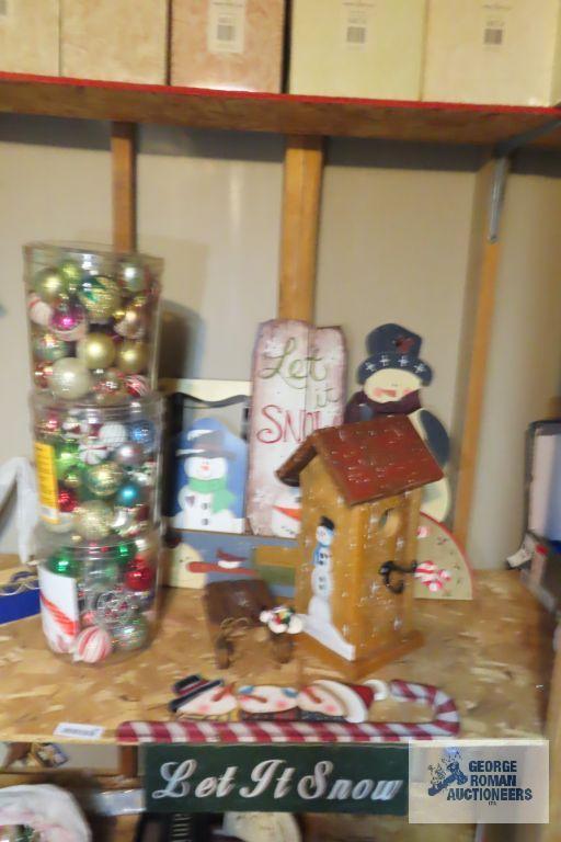 Christmas ornaments, snowman themed birdhouse, and other wooden decorations