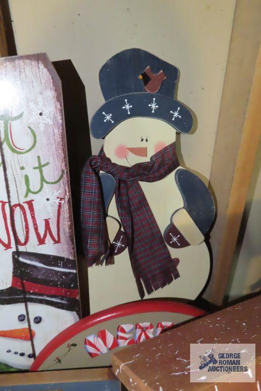 Christmas ornaments, snowman themed birdhouse, and other wooden decorations