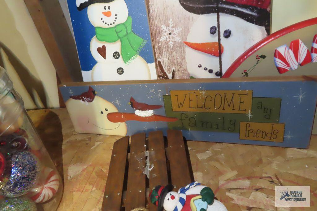 Christmas ornaments, snowman themed birdhouse, and other wooden decorations