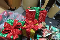 Two totes with Christmas cushions, present decorations, ribbon, throw, etc