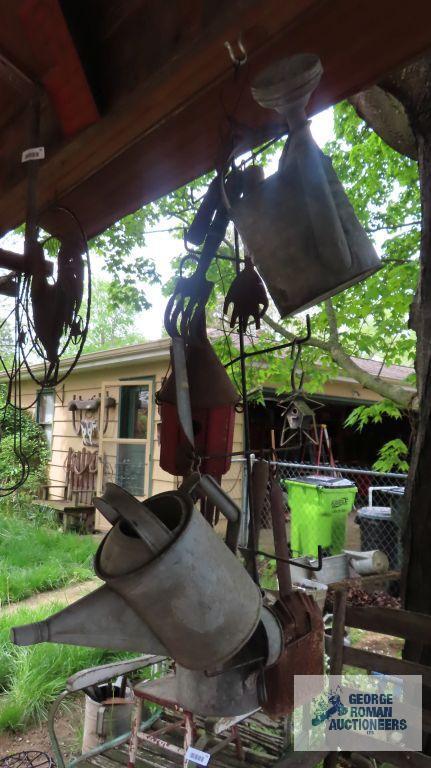 Lot of antique watering cans and birdhouse