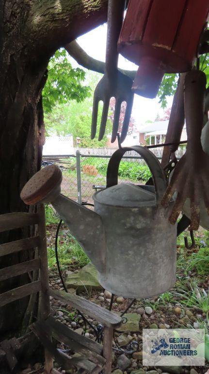 Lot of antique watering cans and birdhouse