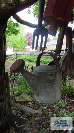 Lot of antique watering cans and birdhouse