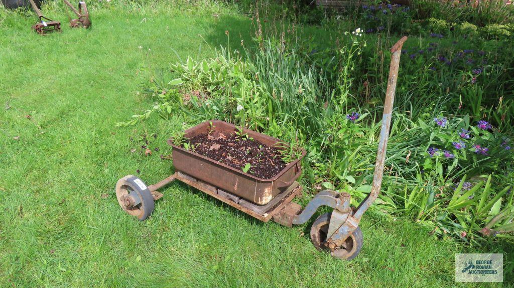 Antique industrial roll about cart with planter