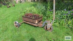 Antique industrial roll about cart with planter