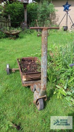 Antique industrial roll about cart with planter