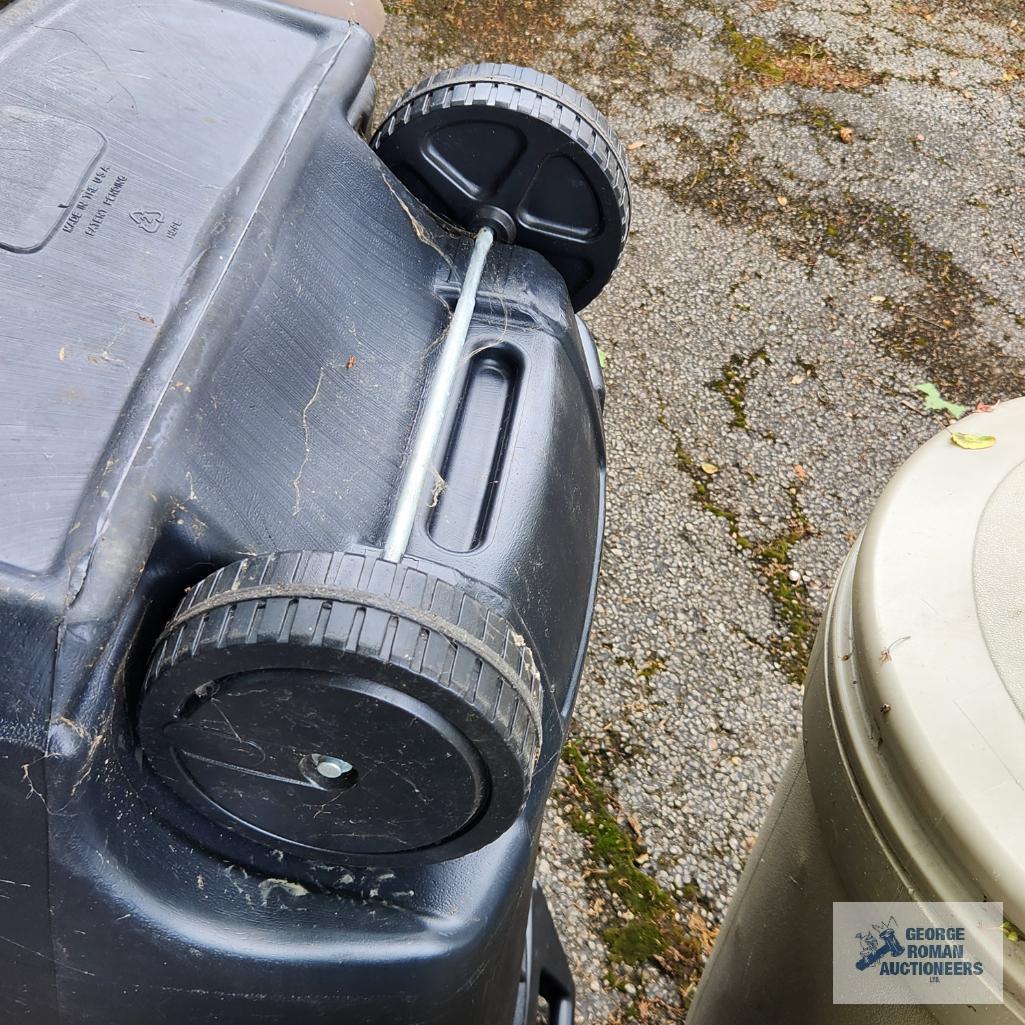 Three roll about trash cans. One has a lid