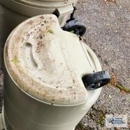 Three roll about trash cans. One has a lid