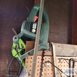 Lot of antique saw parts, yard and garden tools and etc on pegboard and on floor