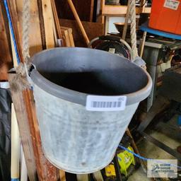 Metal bucket with antique pulley and plastic planter