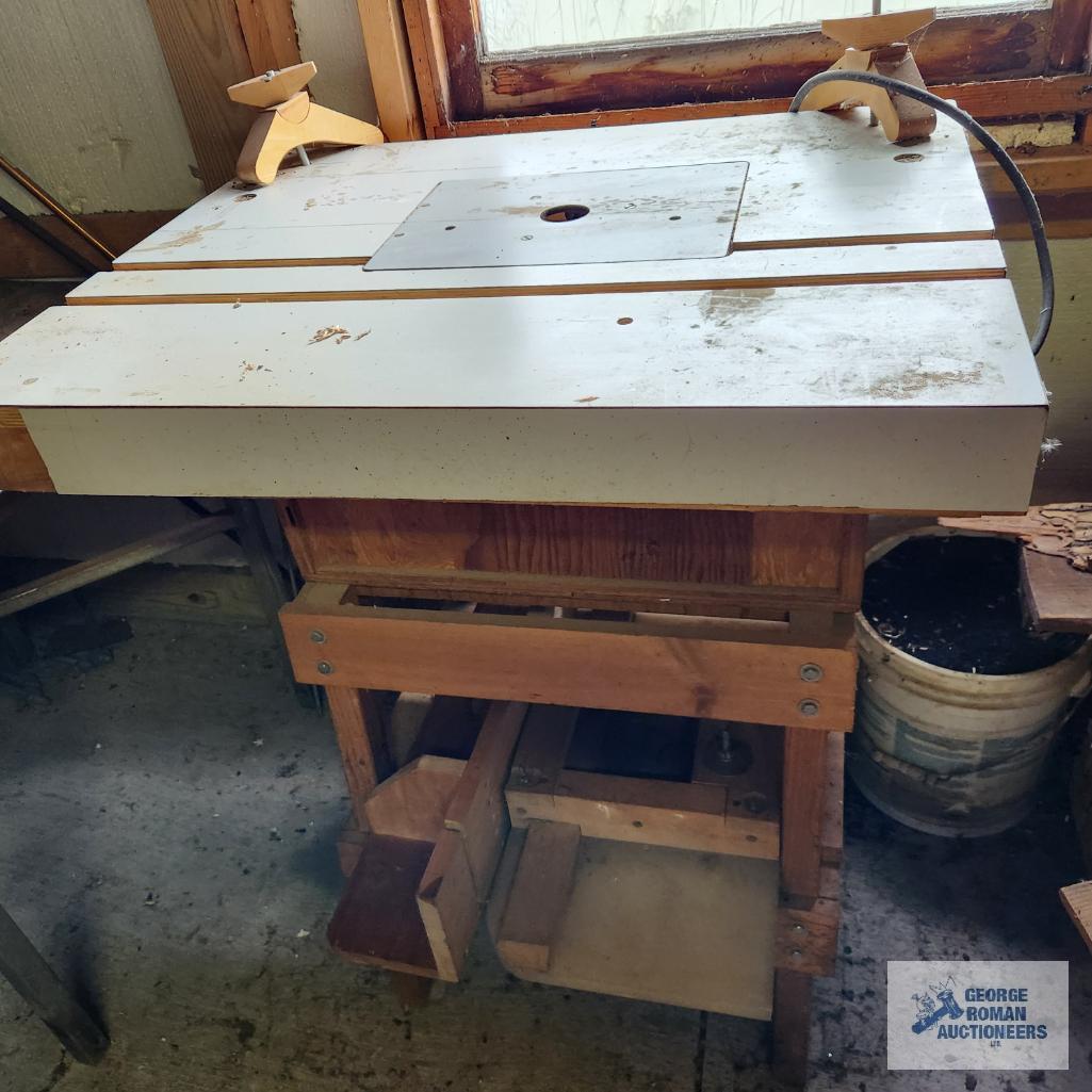 Homemade router table and workbench with wooden top and metal frame