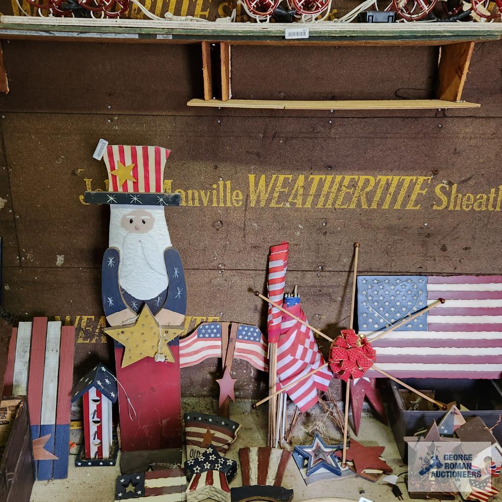 Lot of patriotic decorations including plastic flag, wooden flags, bird houses and Uncle Sam